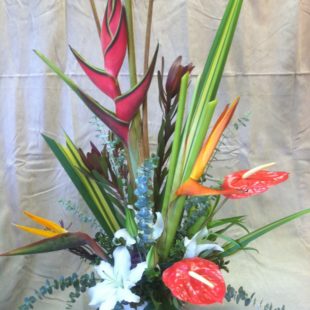 Striking Beauty flower arrangement with, Anthurium, birds of paradise, heliconia, and Lilies