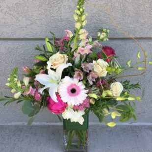 End Of The Rainbow flower arrangement with Daisies, lilies, orchids, and roses