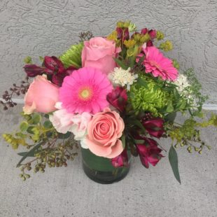 Garden Blooms features a charming mix of Alstroemeria, Daisies, Mums, and Roses