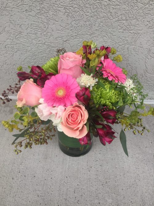 Garden Blooms features a charming mix of Alstroemeria, Daisies, Mums, and Roses