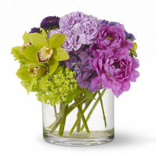 Mad About You flower arrangement with Green orchids and purple dahlias dance gracefully alongside lavender and chartreuse blooms