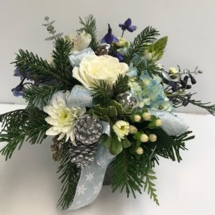 Happy Hannakuh flower arrangement with delightful arrangement featuring blue Delphinium, festive Christmas greens, elegant white Hydrangea, and pristine white Roses.