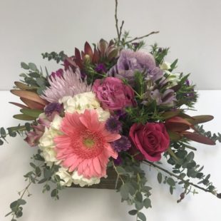 Style me Pretty flower arrangement with array of pink and purple blooms